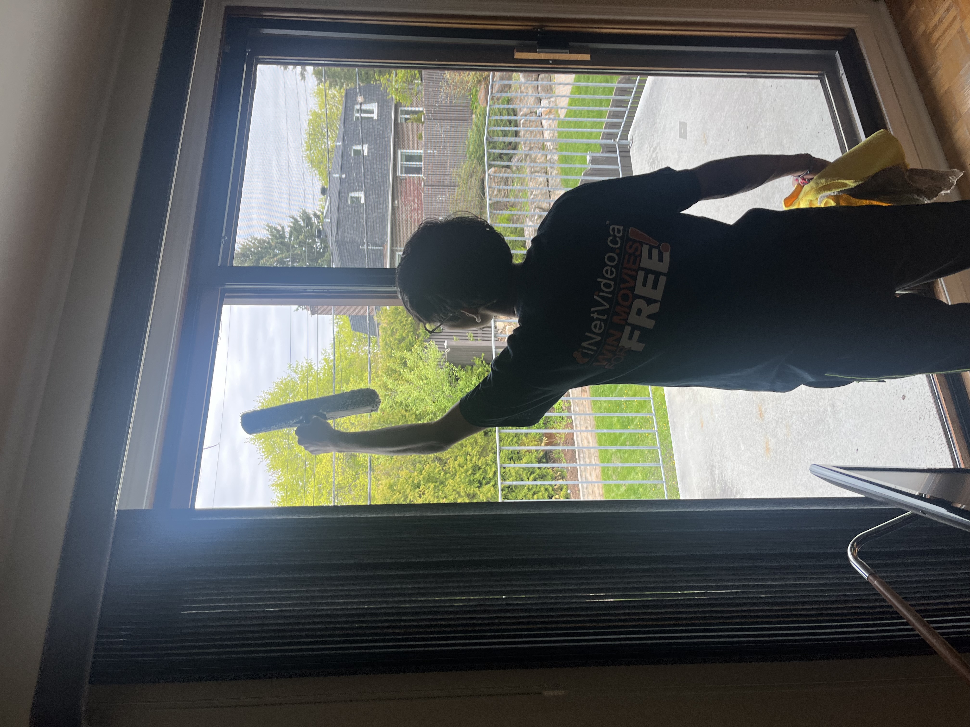 Abbott Maintenance team member cleaning exterior windows
